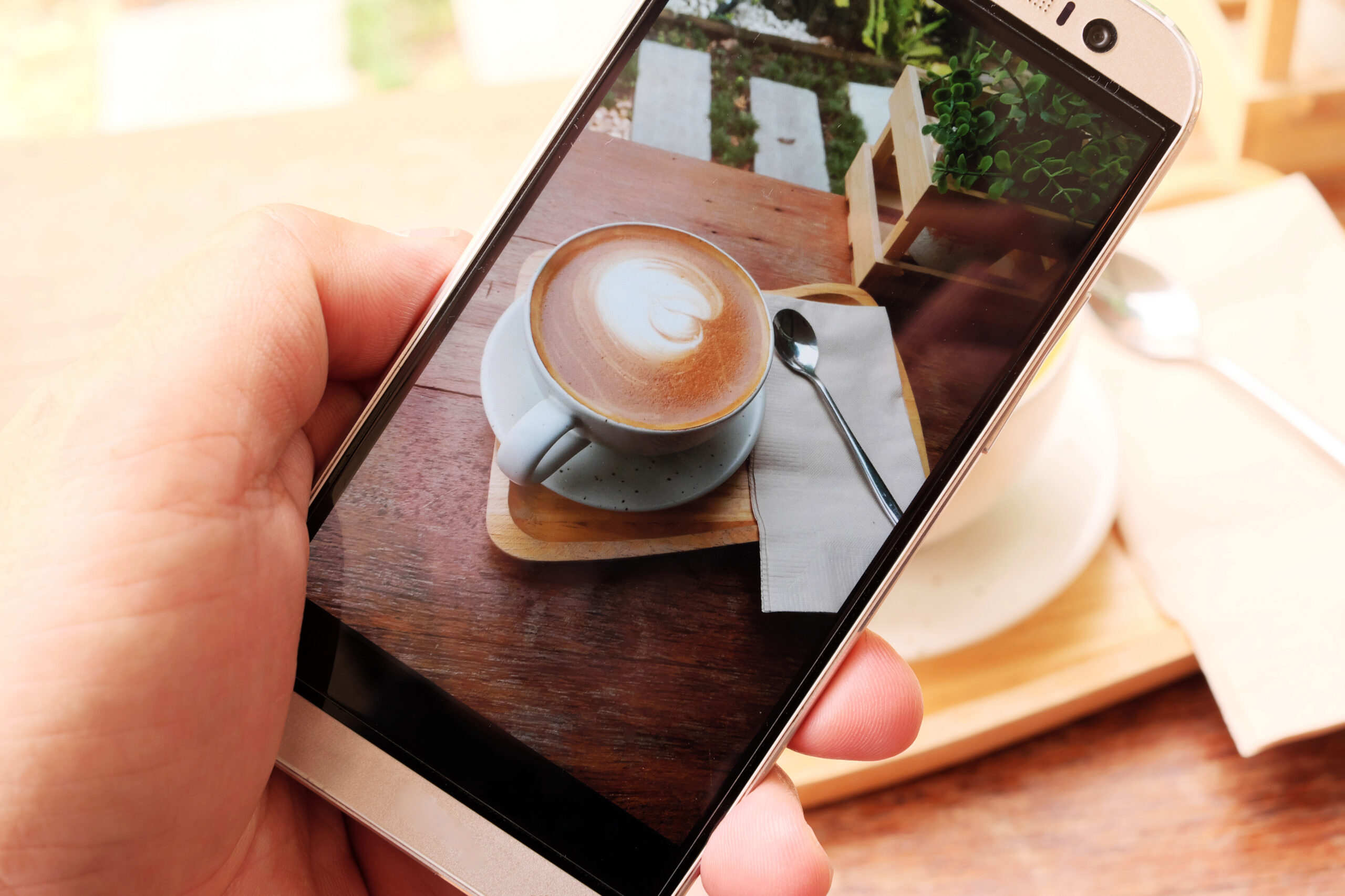capturing latte art on phone at coffee shop 2026 09 25 02 55 54 utc scaled